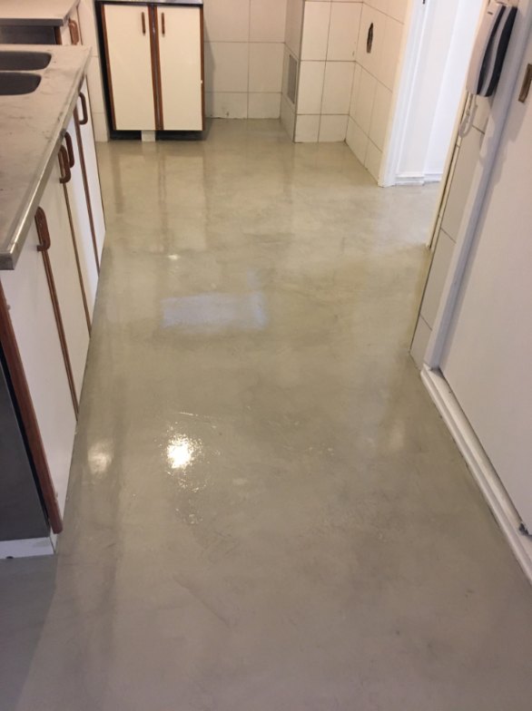 Pasillo de cocina con piso de microcemento satinado